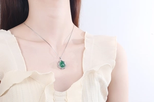 Detail of silver drop necklace with green chalcedony stone and white zircon stones
