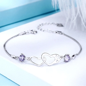 Detail view of S925 sterling silver interlocking heart bracelet with purple gemstones