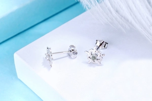 Macro view of S925 sterling silver snowflake stud earrings with bright center zircon stone