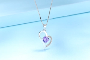 Macro shot of S925 silver heart necklace with purple gemstone and cubic zirconia
