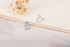 Macro detail of geometric S925 sterling silver stud earrings with sparkling pavé zircons
