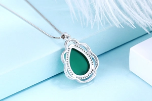 Detailed macro view of S925 silver necklace with teardrop emerald green chalcedony stone