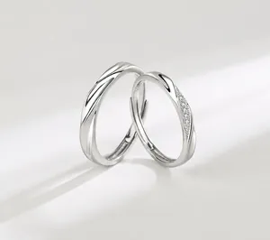Close-up of S925 sterling silver couple rings with twisted rope texture and pavé zircon