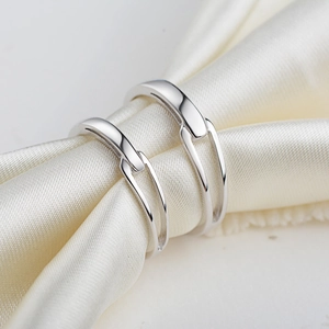 S925 sterling silver Mobius rings for couples on elegant silk background