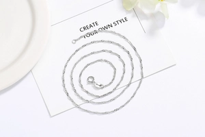 Detailed view of S925 sterling silver water wave chain with a sturdy spring ring clasp