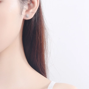 Minimalist S925 sterling silver snowflake earrings with cubic zirconia on female model
