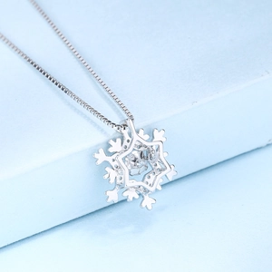 Elegant S925 sterling silver snowflake pendant necklace with cubic zirconia on blue stand