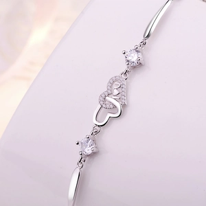 Elegant S925 sterling silver interlocking heart bracelet with I U design and cubic zirconia