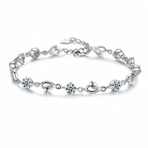 Detail of S925 sterling silver bracelet with hollow heart links and sparkling gemstones