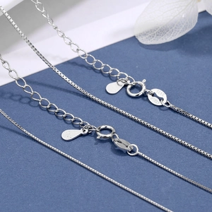 Detail view of S925 sterling silver box chain showing Italy hallmark and spring clasp