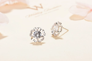 Close-up of S925 sterling silver flower stud earrings with sparkling cubic zirconia stones