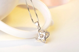Close-up of S925 sterling silver four-leaf clover pendant with sparkling cubic zirconia