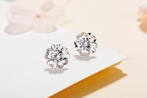 Macro detail of S925 sterling silver flower stud earrings with brilliant zircon center