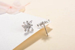 Macro view of S925 sterling silver snowflake stud earrings with sparkling cubic zirconia