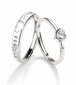 Detail of S925 sterling silver couple rings showing endless love engraving and heart zircon