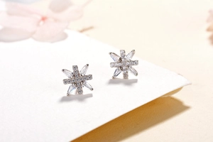 Macro view of S925 sterling silver snowflake stud earrings with sparkling cubic zirconia