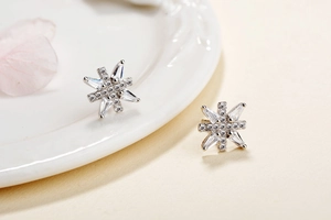 Macro detail of S925 sterling silver snowflake earrings with sparkling cubic zirconia