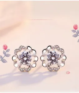 Macro view of S925 silver flower stud earrings with central cubic zirconia stone