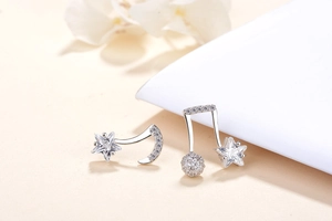 Detailed macro view of S925 silver asymmetric musical note and star crystal stud earrings