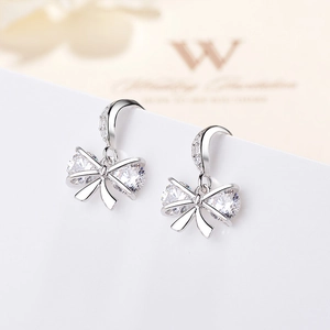 Elegant S925 sterling silver bow earrings with pear-shaped zircon stones and hook design
