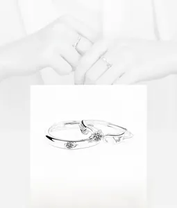 Macro detail of S925 sterling silver angel wing couple rings with zircon inlays