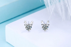 Macro shot of S925 sterling silver reindeer stud earrings with sparkling round crystals