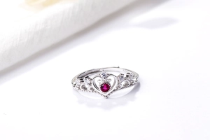 Macro shot of S925 sterling silver crown ring featuring a red heart gemstone and diamonds