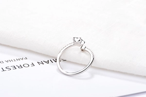 Macro detail of silver star ring with blue zircon inlay and sparkling crown motif