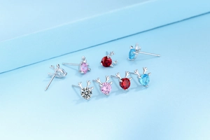 Macro shot of S925 sterling silver reindeer antlers stud earrings with colorful zircons