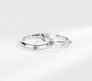 Close-up of S925 sterling silver angel wing couple rings with zircon inlays