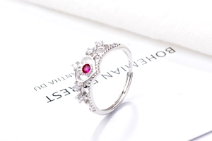 Macro shot of S925 sterling silver crown ring with red zircon and fine engravings