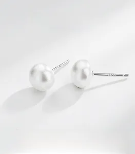 Detailed macro view of S999 sterling silver stud earrings with natural white freshwater pearls