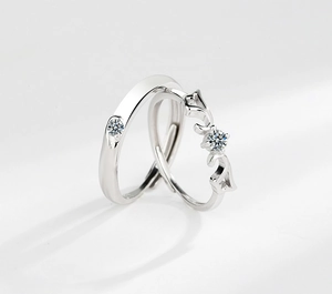 Detailed view of s925 sterling silver couple rings with angel wings and diamonds
