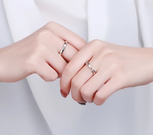 Close-up of S925 sterling silver angel wing rings featuring sparkling zircon stones