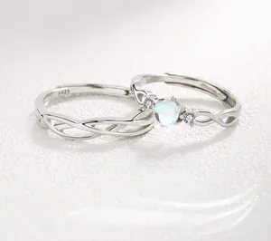 Close-up of S925 silver couple rings featuring a moonstone and twisted design detail