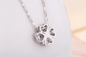Close-up of S999 silver hallmark on the back of a four-leaf clover pendant necklace