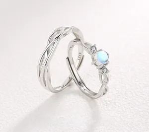 Macro detail of S925 sterling silver couple rings showing the hallmark and blue gemstone