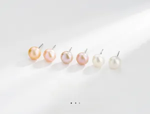 Macro detail of six natural pearl studs in gold, pink, purple, and white with silver pins