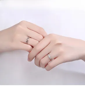 Detailed view of S925 silver couple rings featuring woven band and triple stone setting