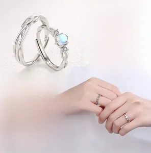 Detail of S925 sterling silver couple rings showing S925 hallmark and blue moonstone