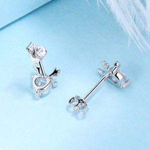 Macro detail of S925 sterling silver reindeer earrings with round sparkling zircon