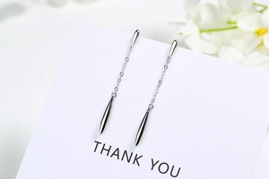 Close-up of S925 sterling silver long drop earrings with polished water drop pendants