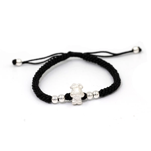 Detailed shot of handmade black braided rope bracelet with silver zodiac rabbit charm