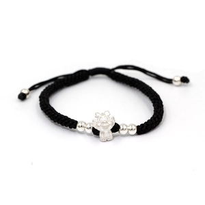 Detail of adjustable black woven bracelet with silver dragon charm and decorative beads