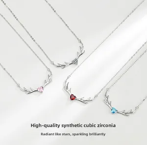 Detail of deer antler heart pendants with colorful cubic zirconia in four shades