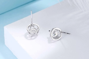 Close-up of S925 sterling silver four-leaf clover stud earrings with sparkling round zircon