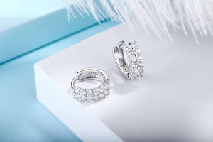 Close-up of S925 sterling silver earrings with three-row pavé-set round cubic zirconia