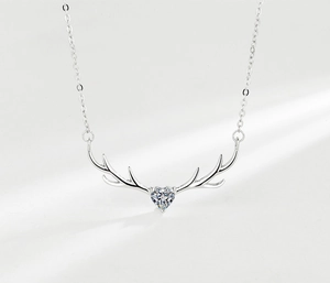 Close-up of S925 silver deer antler necklace with heart-shaped zircon pendant and chain