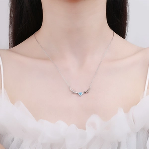 Elegant S925 sterling silver reindeer necklace with a blue heart zircon on female model