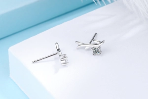 Detail showing S925 hallmark on silver leaf earrings with sparkling cubic zirconia